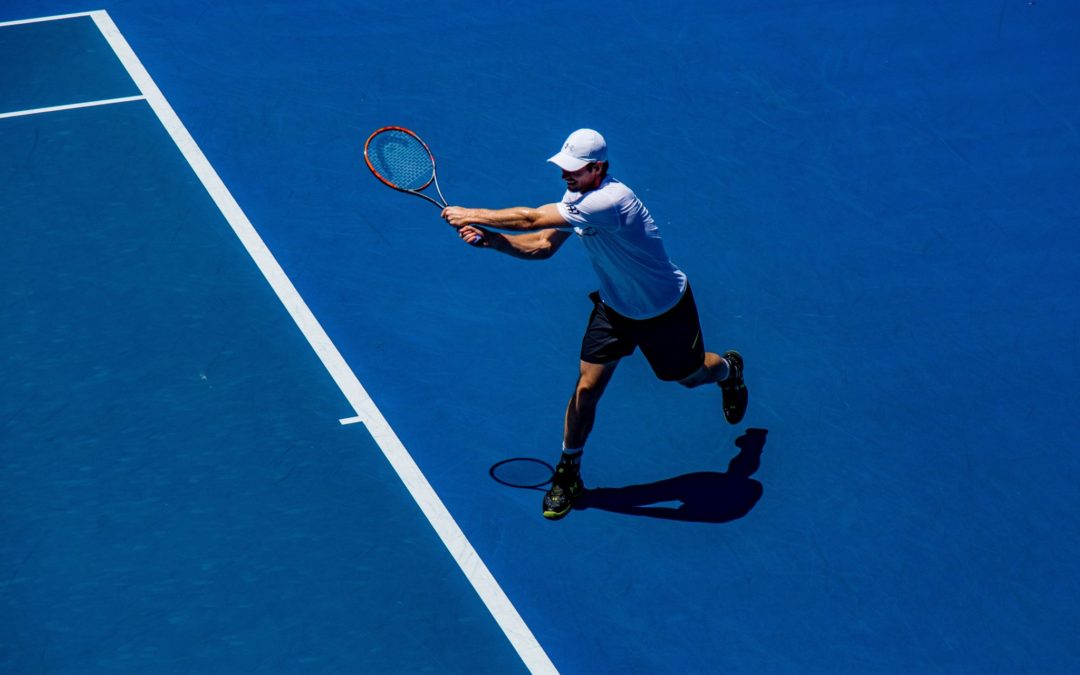 Tennis player hitting ball with racquet