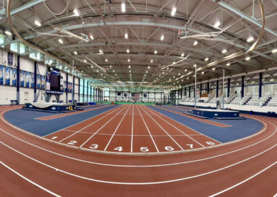 Indoor track at Penn State University featuring blue and red lines, designed for athletic training and events.