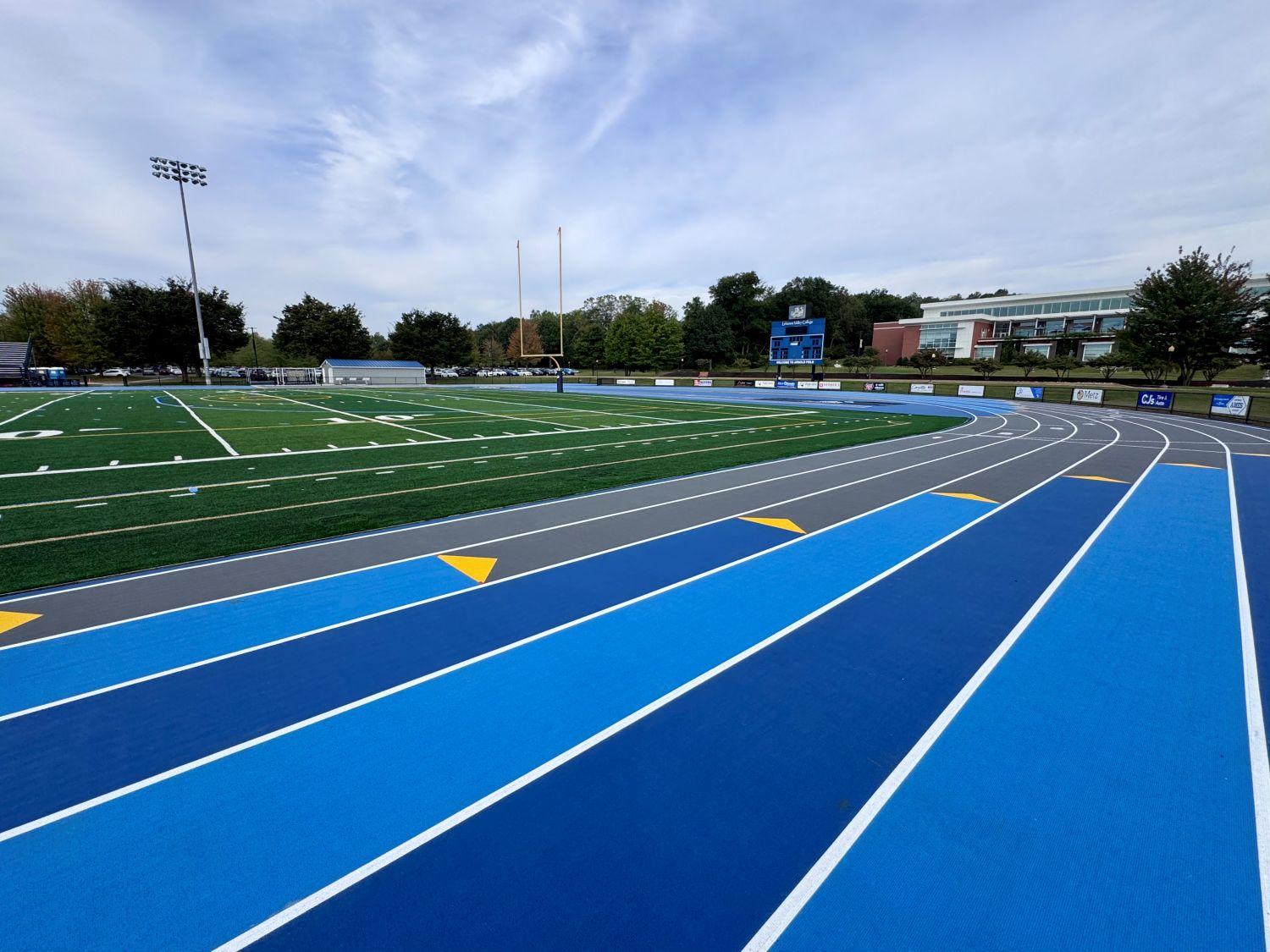 Completed Mondo track and field installation at Lebanon Valley College featuring bright blue running surface, multi-lane sprint straightaway, and green artificial turf infield