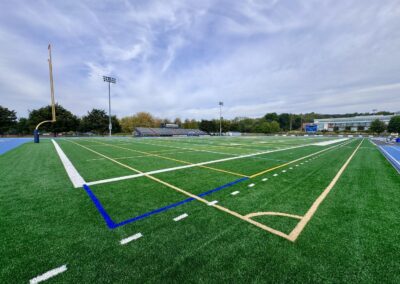 Completed Mondo track and field installation at Lebanon Valley College featuring bright blue running surface, multi-lane sprint straightaway, and green artificial turf infield