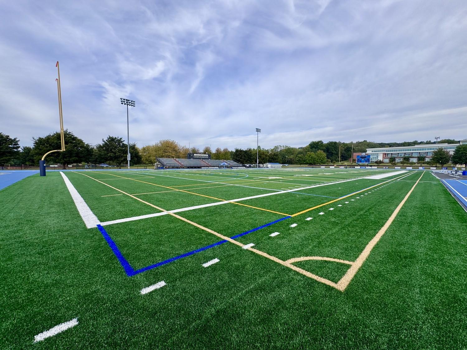 Completed Mondo track and field installation at Lebanon Valley College featuring bright blue running surface, multi-lane sprint straightaway, and green artificial turf infield