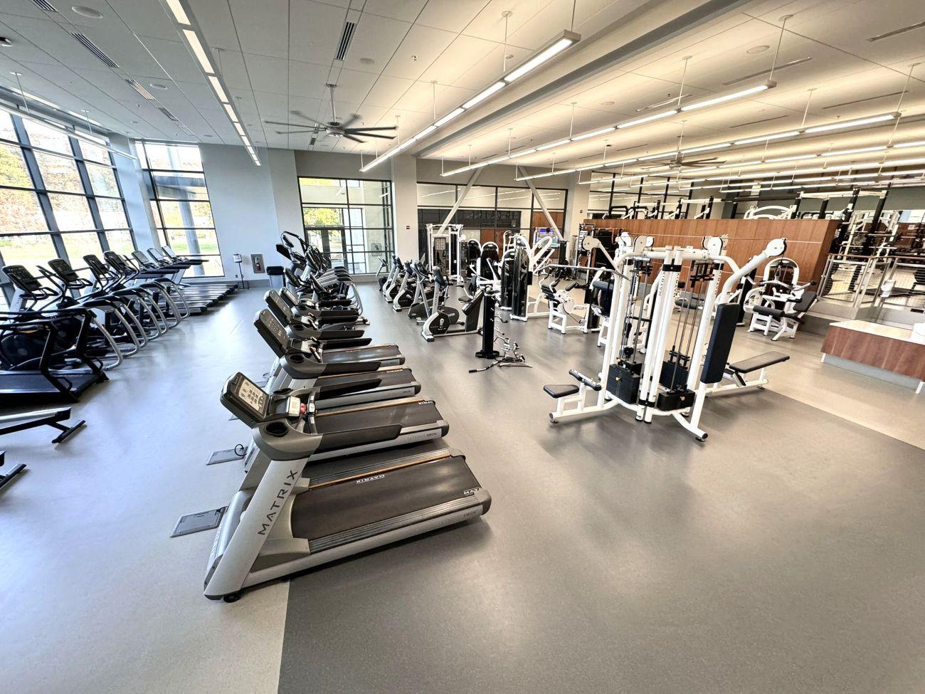 Completed fitness center and weight room renovation at Penn State Berks featuring cardio equipment, power racks, and Penn State Nittany Lion branding